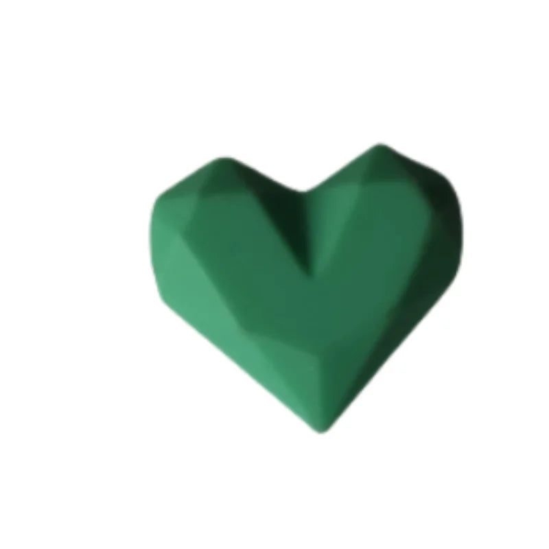 Green heart-shaped silicone dust plug for Tamagotchi Uni, perfect for protecting your electronic pet charging port.
