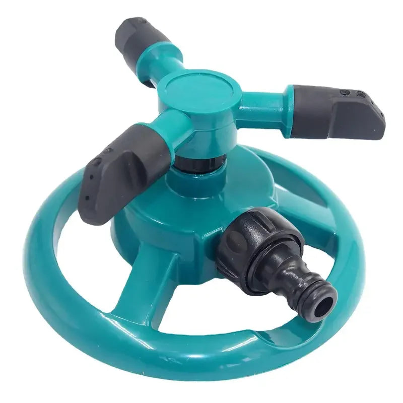 Close-up of teal rotary sprinkler with three black nozzles and a round spray wheel base.