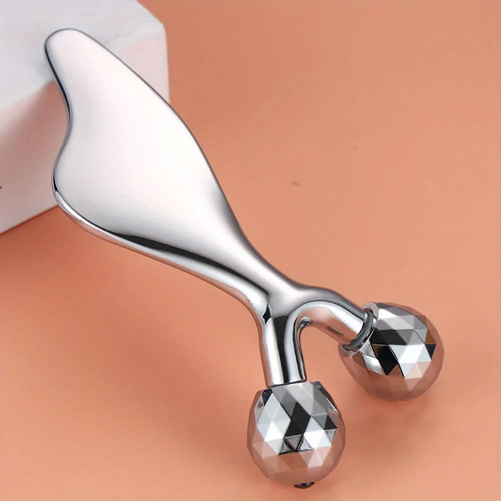 Silver metallic 2-in-1 facial tool with a smooth gua sha handle and two faceted, Y-shaped rolling massage spheres.
