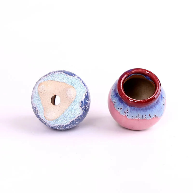 Mini ceramic flowerpot for succulent, pink and blue crackle glaze, drainage hole visible.