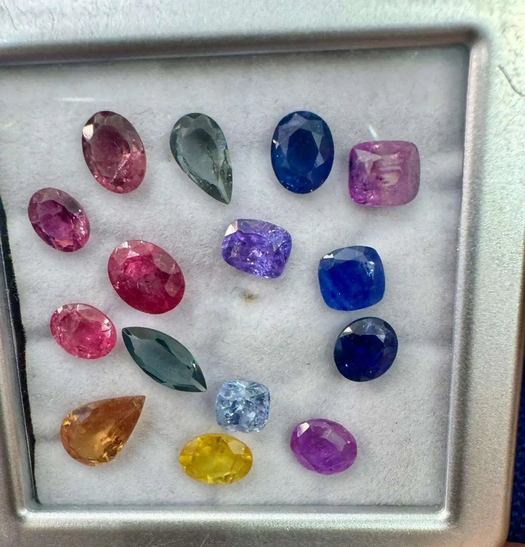 Natural sapphire gemstone mix with oval and cushion-cut faceted stones in metal tray