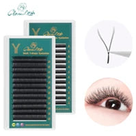 Black Y-shaped false eyelash extension strips on a green tray, with a close-up of application on an eyelid.