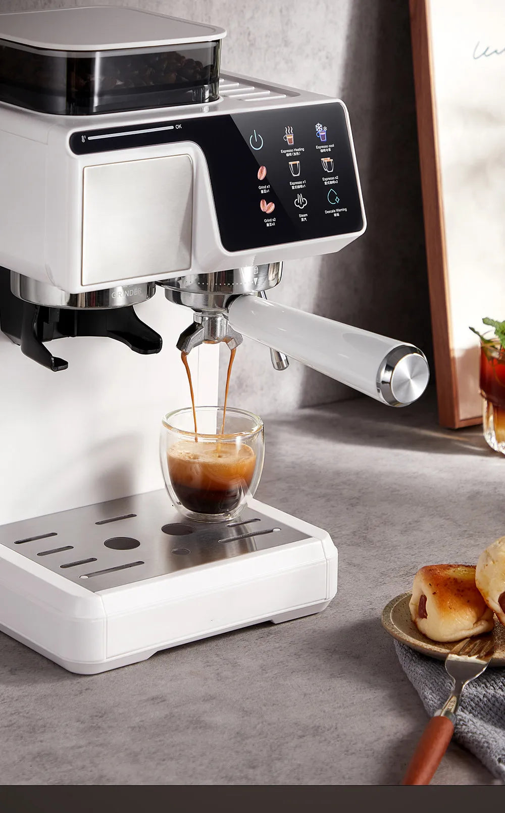 White espresso machine with integrated grinder, digital touchscreen, and stainless steel drip tray pouring into a glass.
