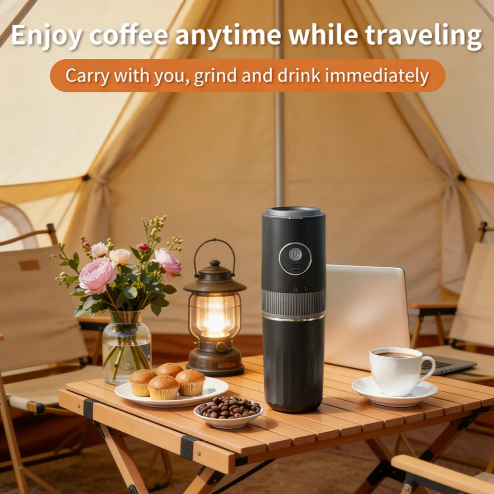 Portable black cylindrical electric coffee grinder and maker on camping table for travel brewing.