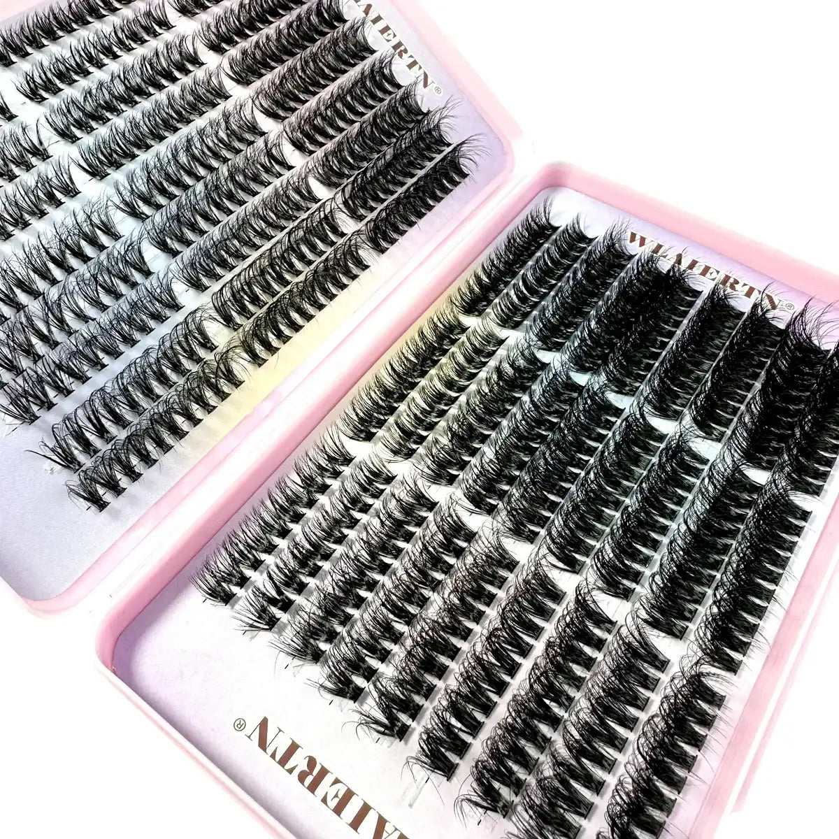 Two pink trays filled with rows of black individual cluster eyelashes for professional cosmetic eye makeup application.