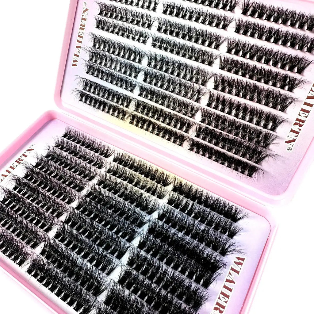 Rows of black synthetic individual eyelash clusters arranged in a two-part pink storage case.
