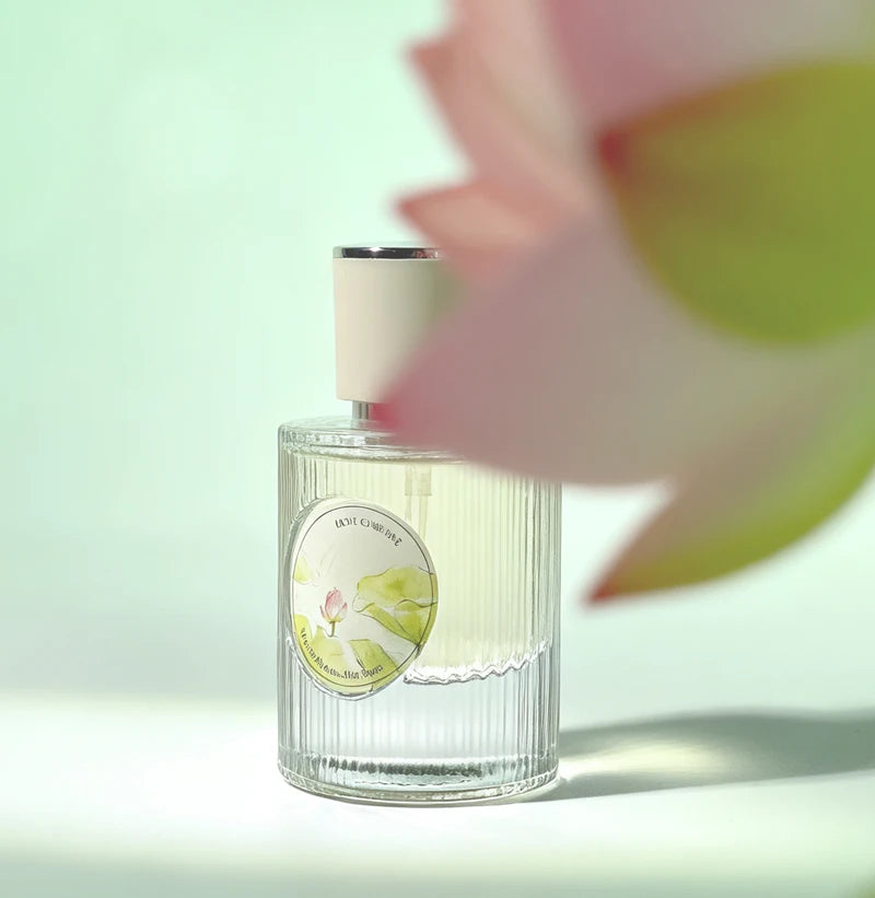Fresh Lotus women's perfume, floral woody EDP with lotus and jasmine, in a ribbed glass bottle with a round label.