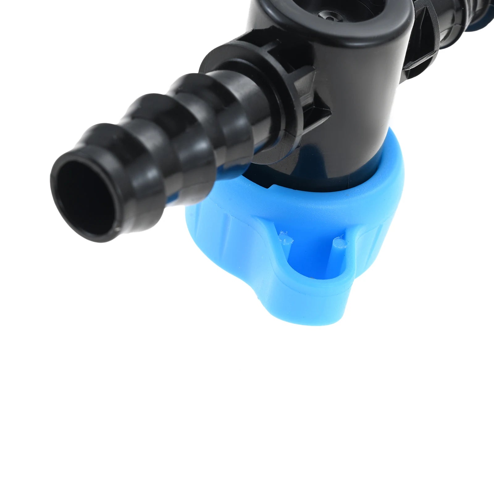 Close-up 1/2 in drip irrigation barbed shut-off valve, black barbs, blue base
