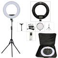 Black ring light with tripod stand, phone holder, power adapter, remote control, and carrying case for photography.