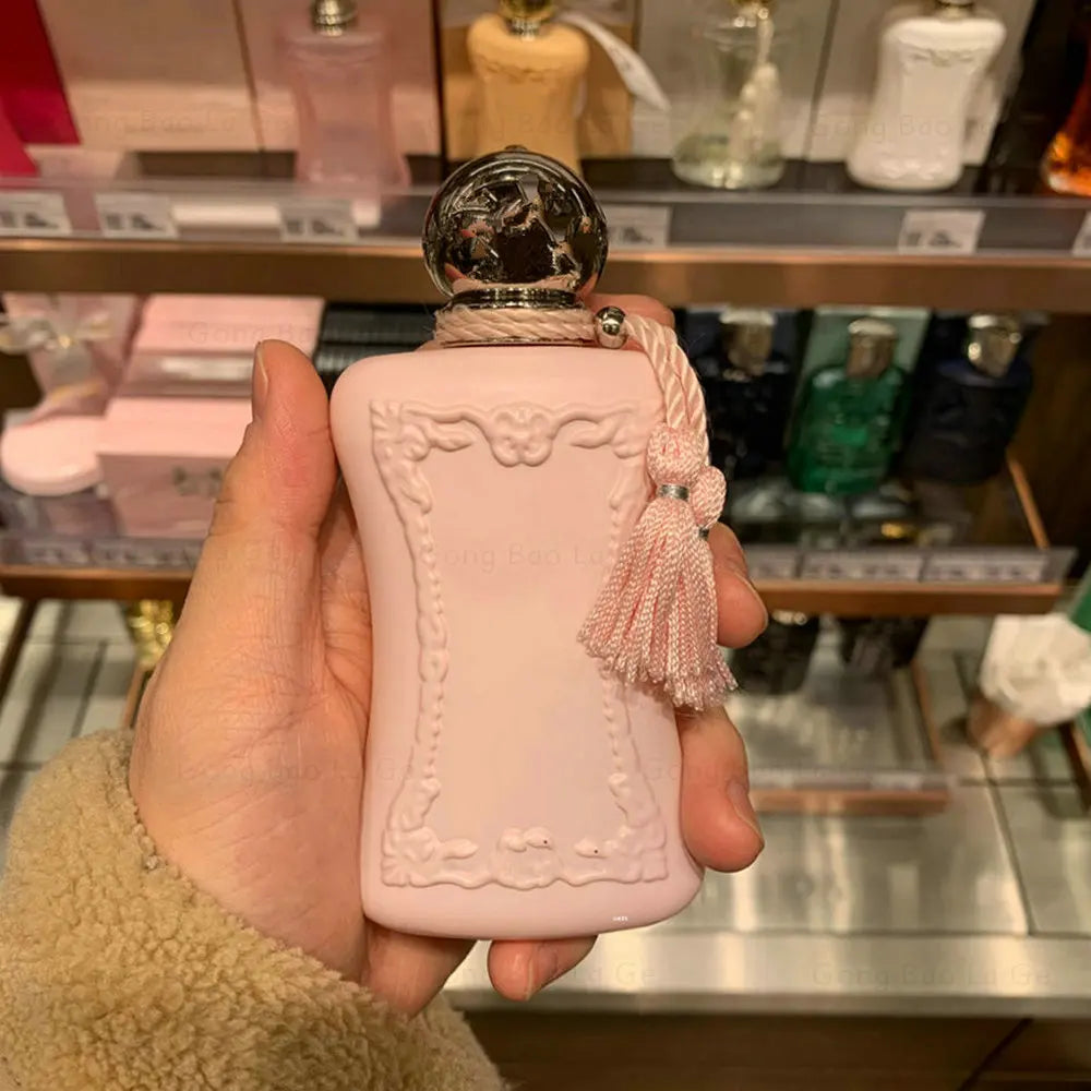 Luxury Delina 75ml Eau de Parfum for women, pink ornate bottle with tassel, floral pheromone fragrance spray.