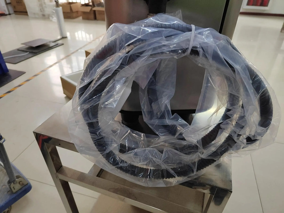Printer hose or cable roll in clear plastic wrap, black with blue edging