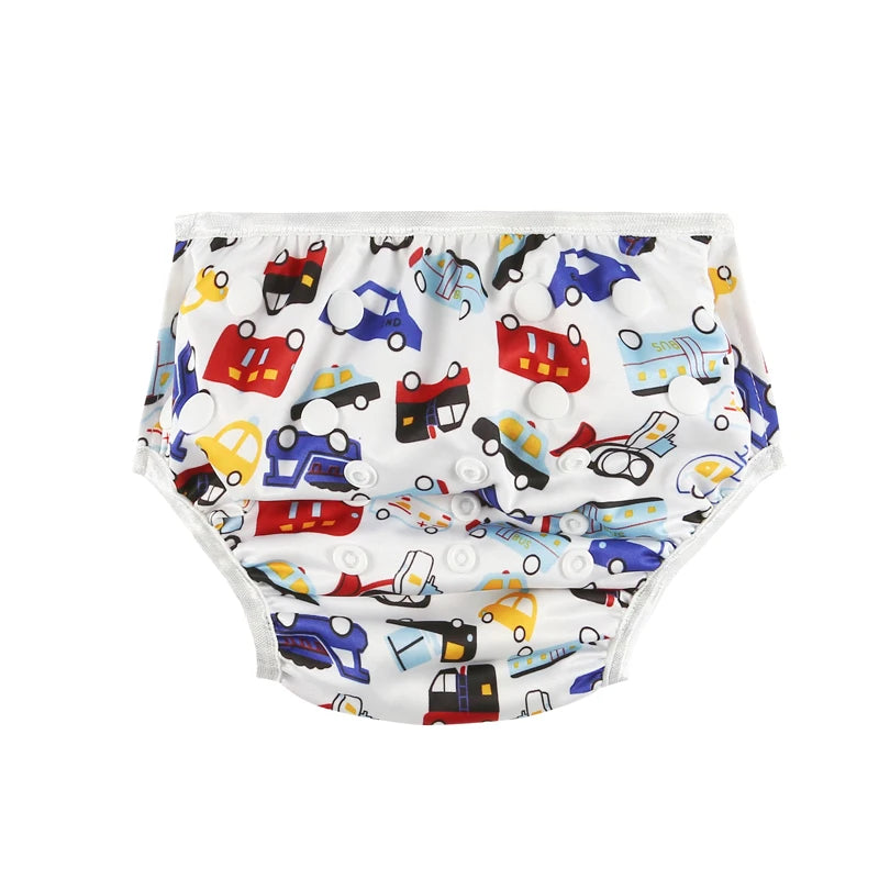 Reusable cloth baby diaper with colorful vehicle and car print, featuring adjustable snap buttons.