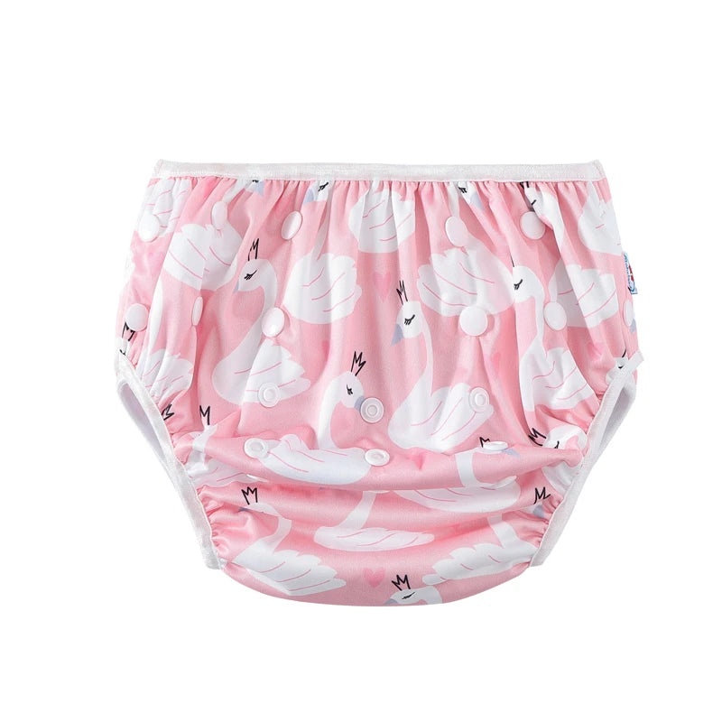Pink reusable baby diaper with white swan print and snap closures for adjustable fit.
