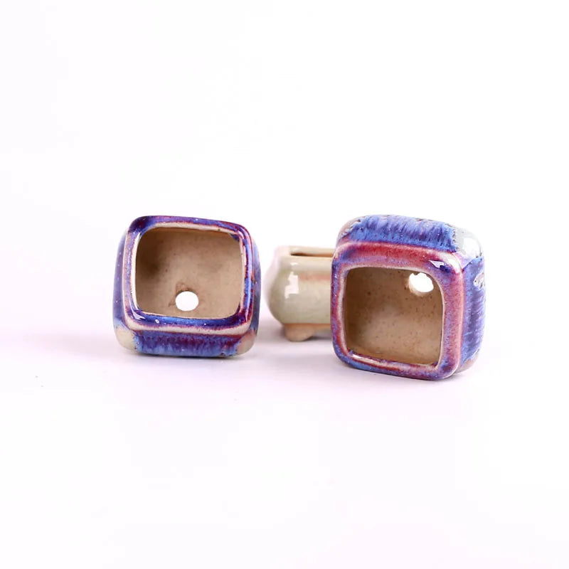 Mini ceramic succulent pots with square drainage openings, blue-purple and beige pair