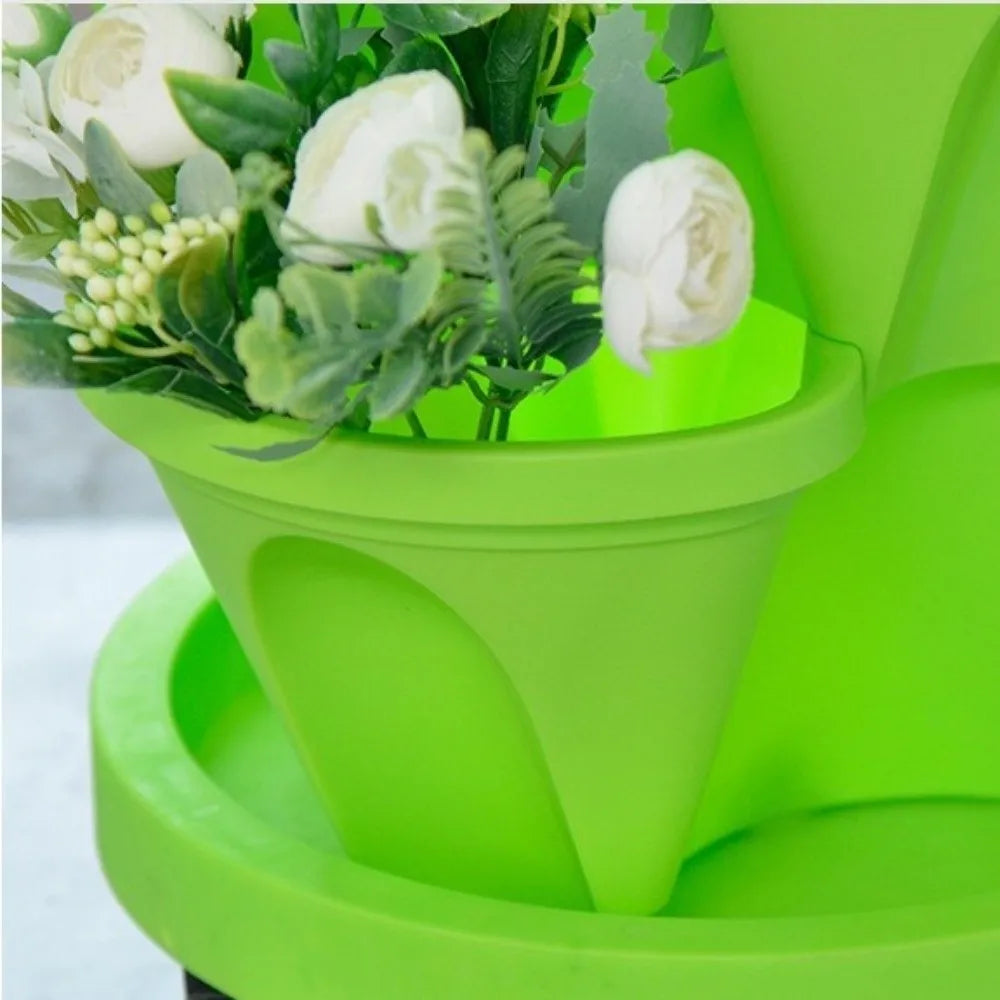 Green plastic 4-petal planter cup with central black drainage insert and smooth raised rim