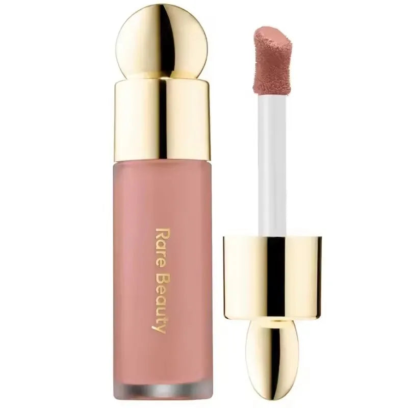 Rare Beauty matte liquid lipstick in a soft nude shade with gold applicator, featuring a smooth, moisturizing texture.