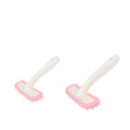 Small pink and white silicone pet grooming brush for rabbits, cats, and guinea pigs to gently remove loose hair.