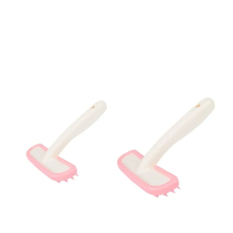 Small pink and white silicone pet grooming brush for rabbits, cats, and guinea pigs to gently remove loose hair.