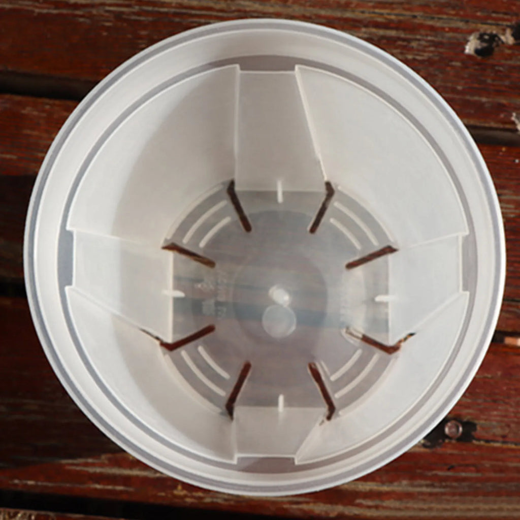 Round white resin planter bottom with drainage hole pattern