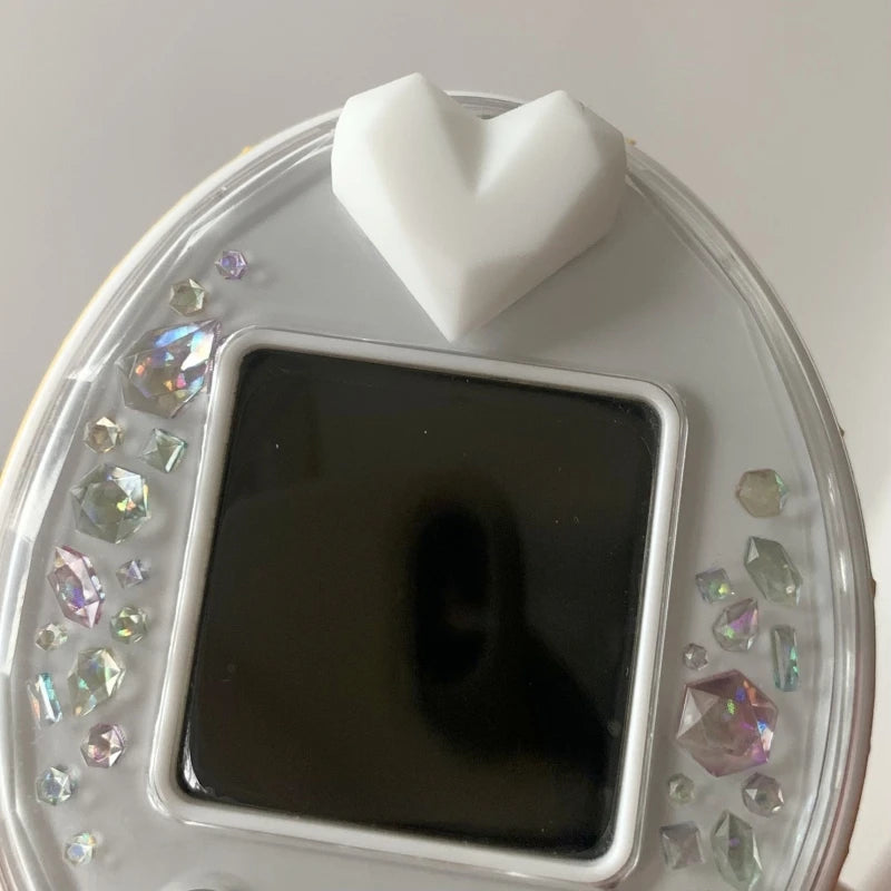 White heart silicone dust plug for Tamagotchi Uni, keeps ports clean with a stylish, protective charm.
