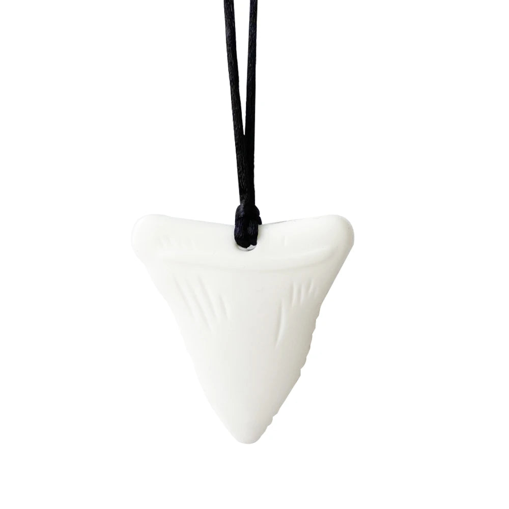 White silicone shark tooth baby teething toy necklace on a black cord for soothing relief.