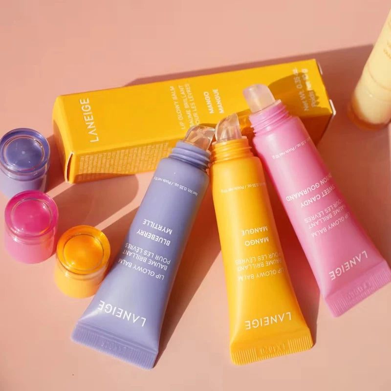 Laneige Lip Glowy Balm trio in purple, yellow, and pink tubes with glossy, moisturizing polypeptide serum texture.