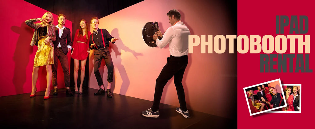 iPad photo booth with a round ring light stand, used for capturing group photos at events against a red wall.