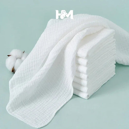 H&M white muslin baby care washcloths, pack of 7, soft cotton texture for gentle baby skin cleaning.
