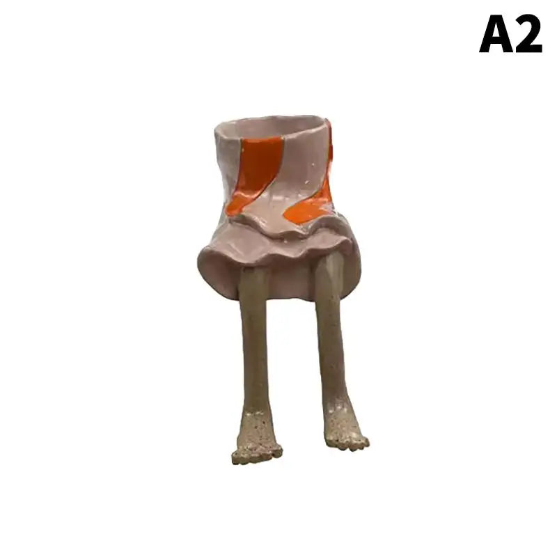 Resin leggy planter figurine with orange panel pot and light beige legs