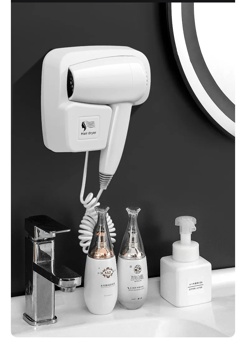 White wall-mounted bathroom hair dryer with coiled cord and sleek design for hotel or home hair care styling.