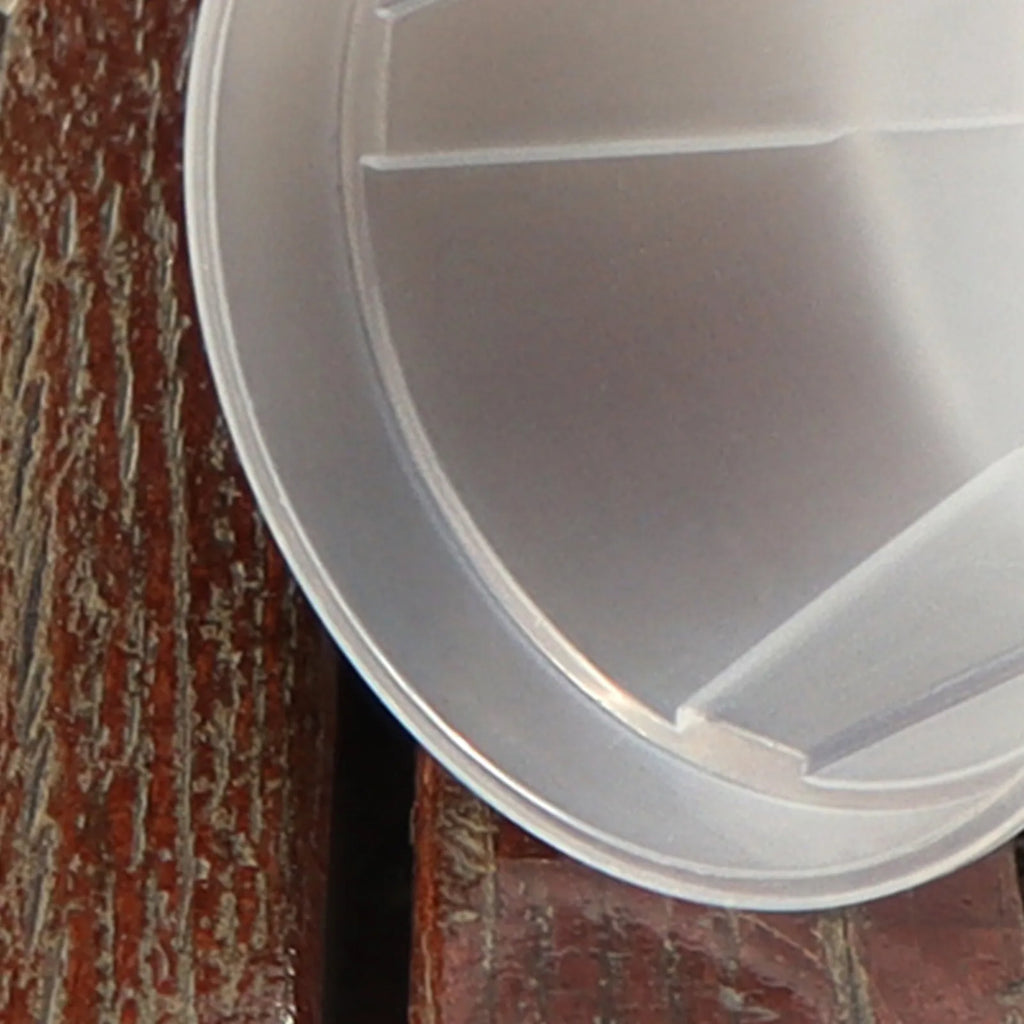 Round white resin planter with ribbed interior corner and drainage channel