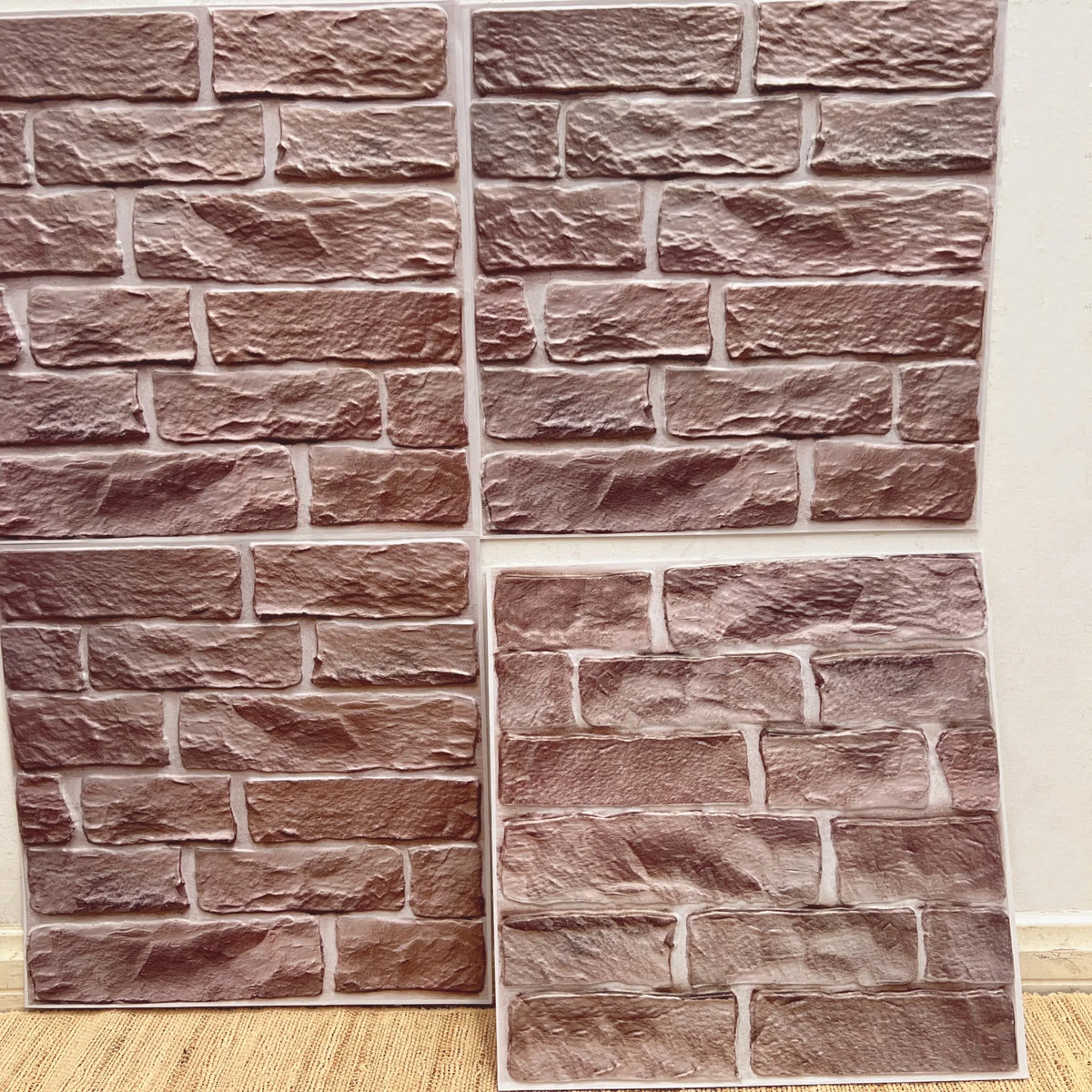 Peel-and-stick backsplash tile sheet with faux brick pattern in dusty rose and light pink