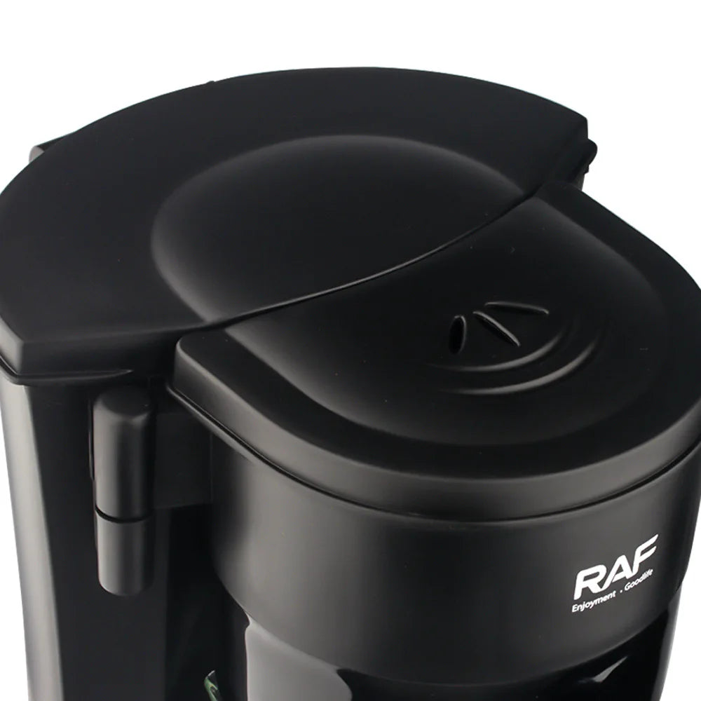Close-up of matte black RAF coffee maker showing top lid and brand logo against a white background.