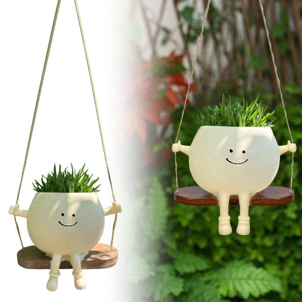 Pair of hanging swing succulent planters shaped like smiling pots with wooden seats