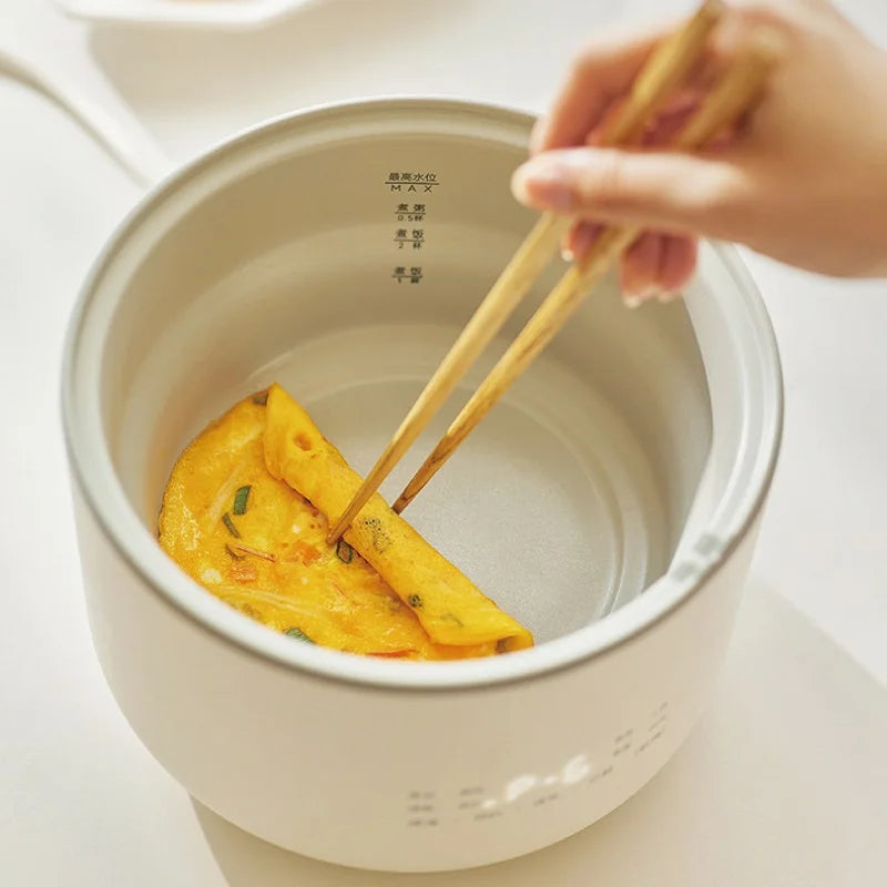 1.5L electric rice cooker with inner pot, holding sliced vegetables with chopsticks