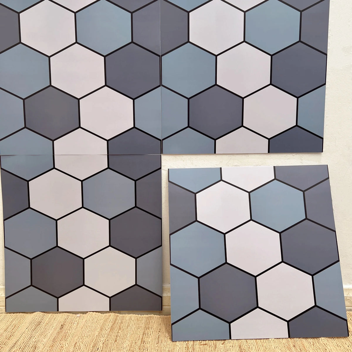 Hexagon-pattern peel-and-stick backsplash tiles with black, white, and gray tones (12 in x 12 in).
