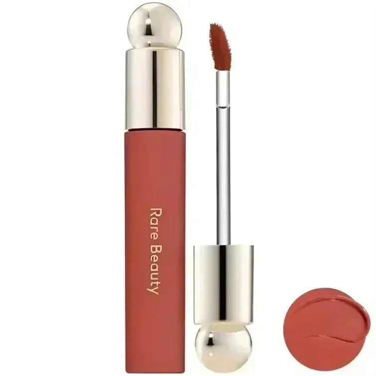 Rare Beauty matte liquid lipstick in a rich, smooth terracotta shade with applicator and color swatch.