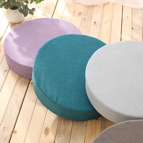 Round linen meditation cushions in purple, teal, and grey for peaceful mindfulness practice.