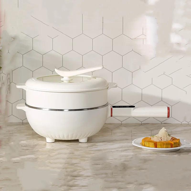 Electric cooking pot with lid on white base, standalone countertop view