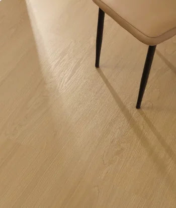 SPC click flooring plank close-up with warm light wood grain and matte finish