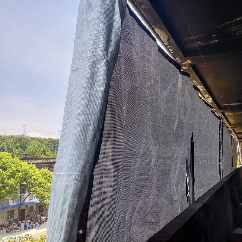 Silver anti-UV sunshade net curtain panel attached along a structure edge
