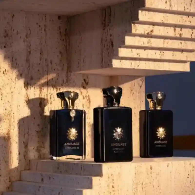 Amouage Interlude Men EDP: Luxury woody aromatic 100ml fragrance in iconic dark square bottles on stone display.