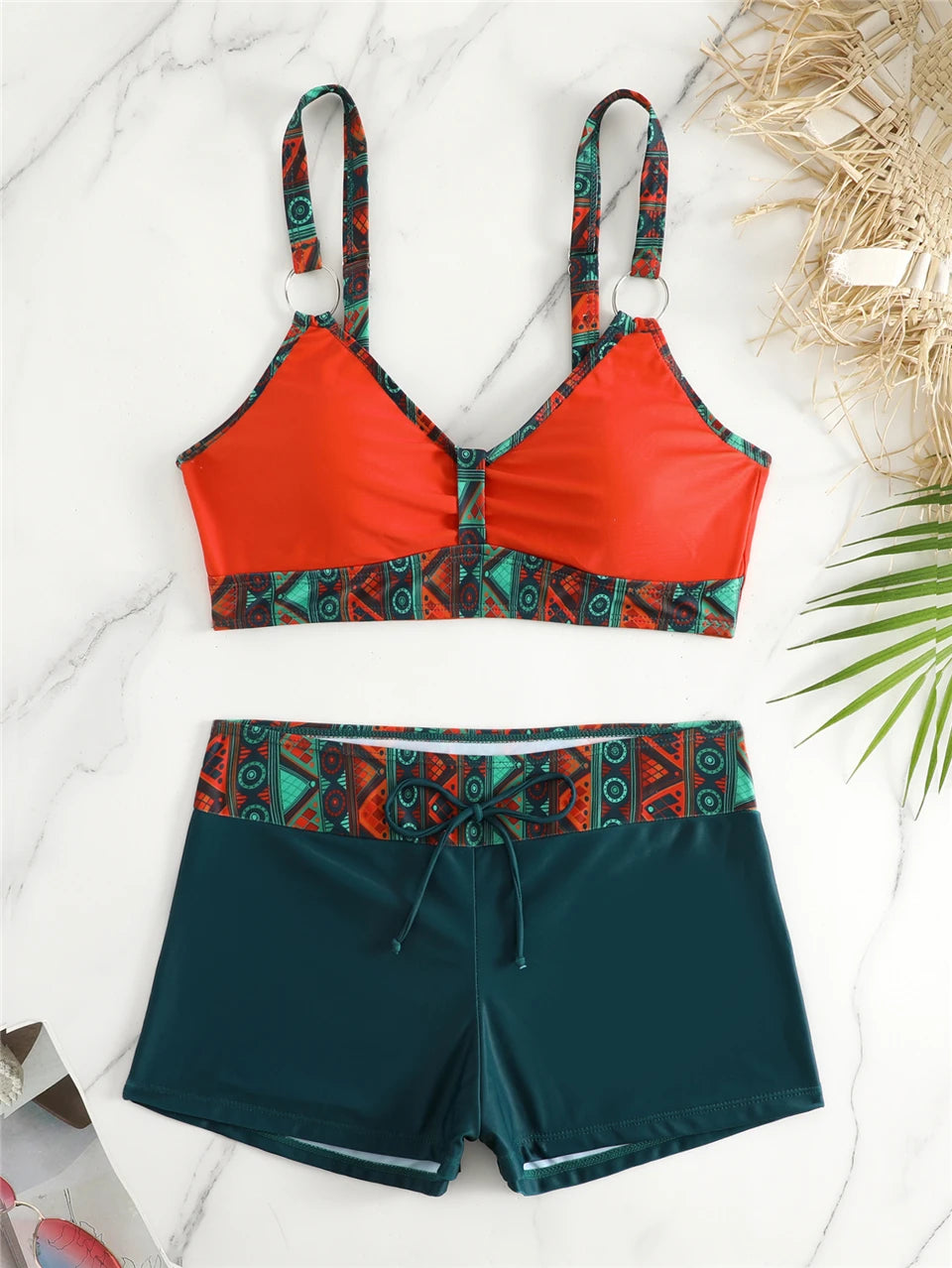 Tidesmit high-waisted bikini with orange padded top and teal shorts featuring tribal print trim and drawstring detail.