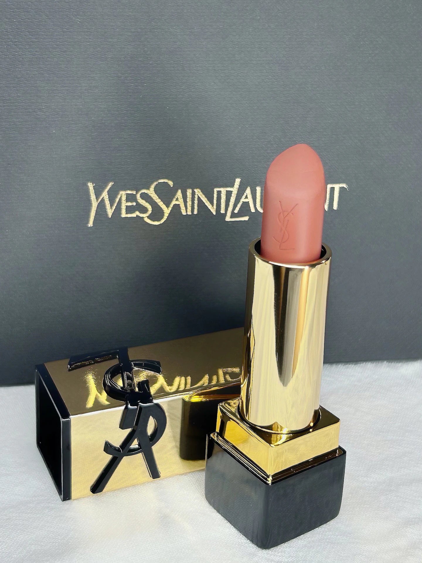 YSL Rouge Pur Couture Nu Muse mini lipstick in a nude satin finish with gold casing and branded black box.