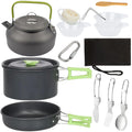 Aluminum camping cookware set with black kettle, nested pot, pan, and green utensil pieces