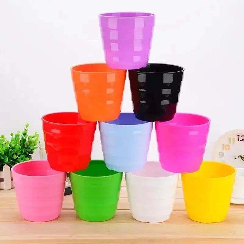 Assorted colorful plastic flower pots with matching saucers, desktop succulent planters