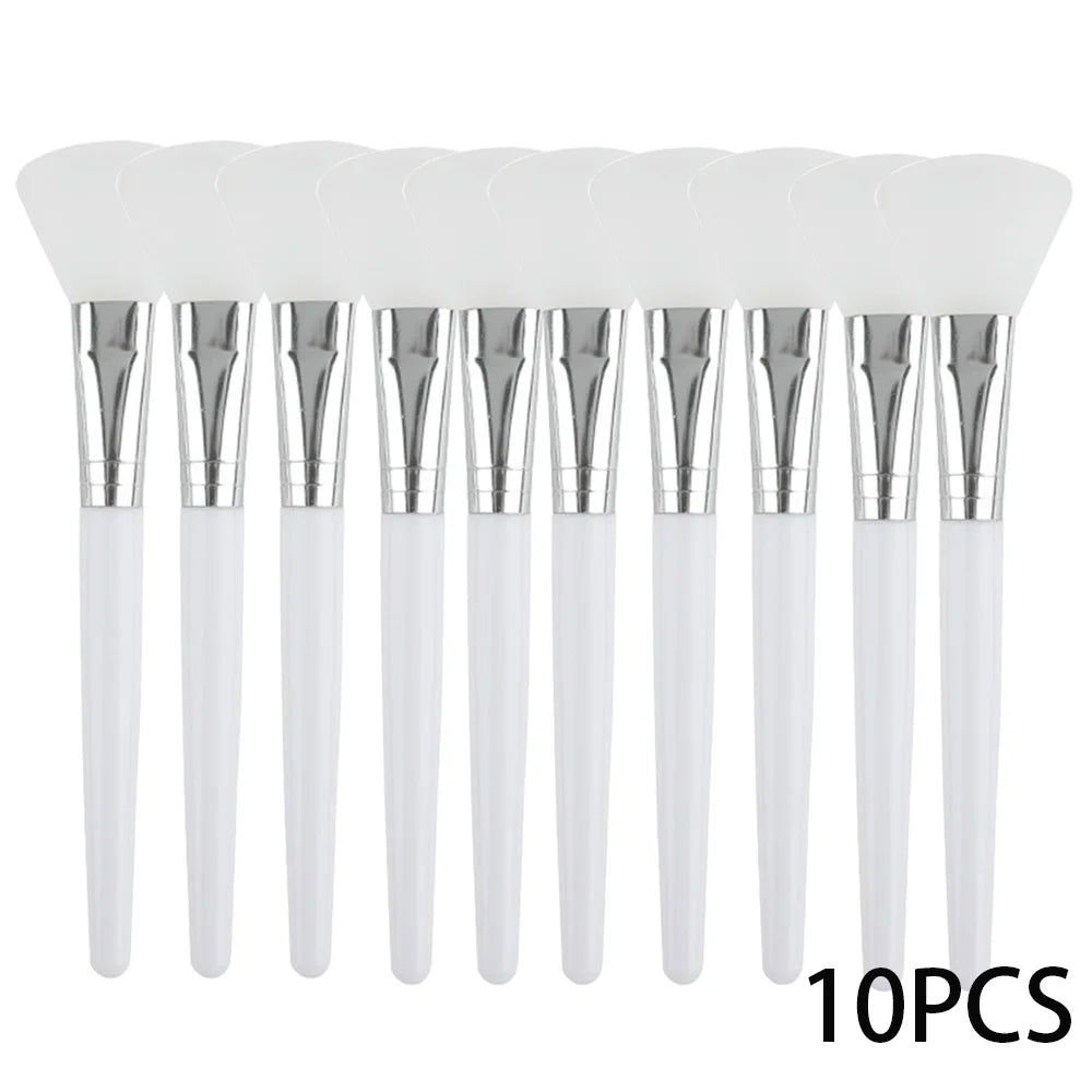 Ten identical face mask applicator brushes with white silicone heads, silver ferrules, and white handles.