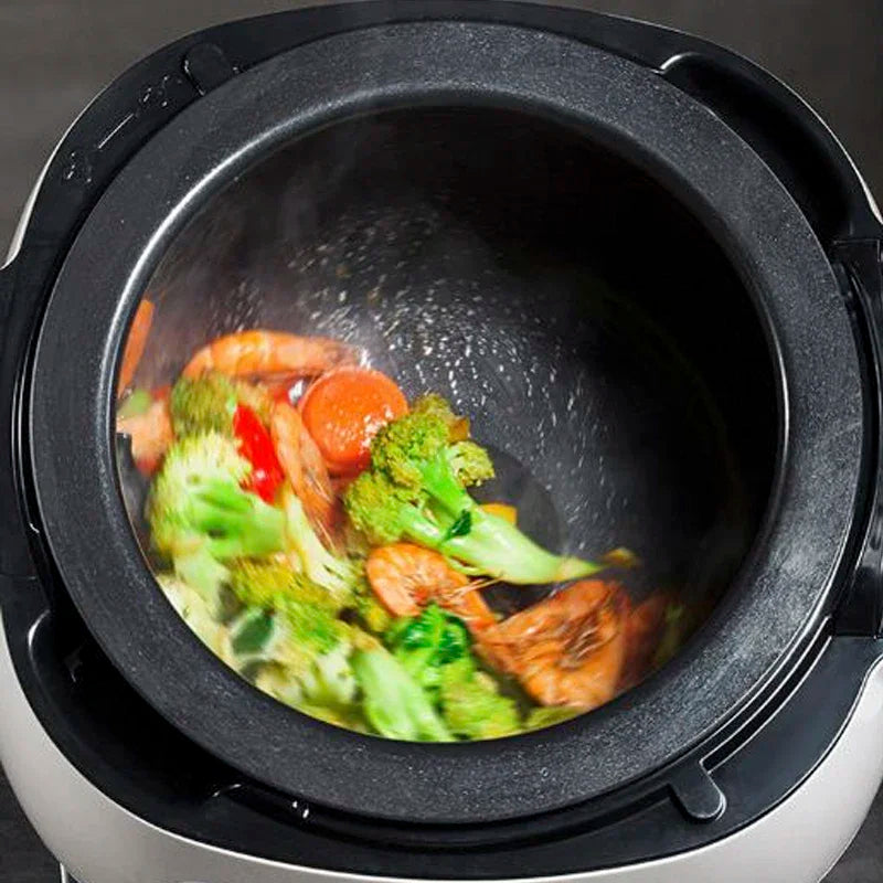 Nonstick cooking pot drum with mixed vegetables inside, steam visible