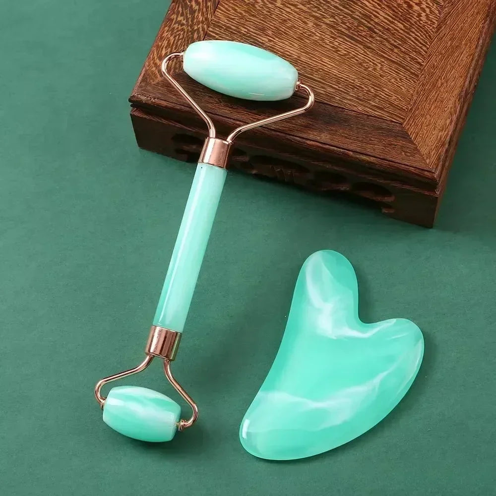 Light green resin facial roller and heart-shaped Gua Sha stone tool set for anti-aging and skin massage.