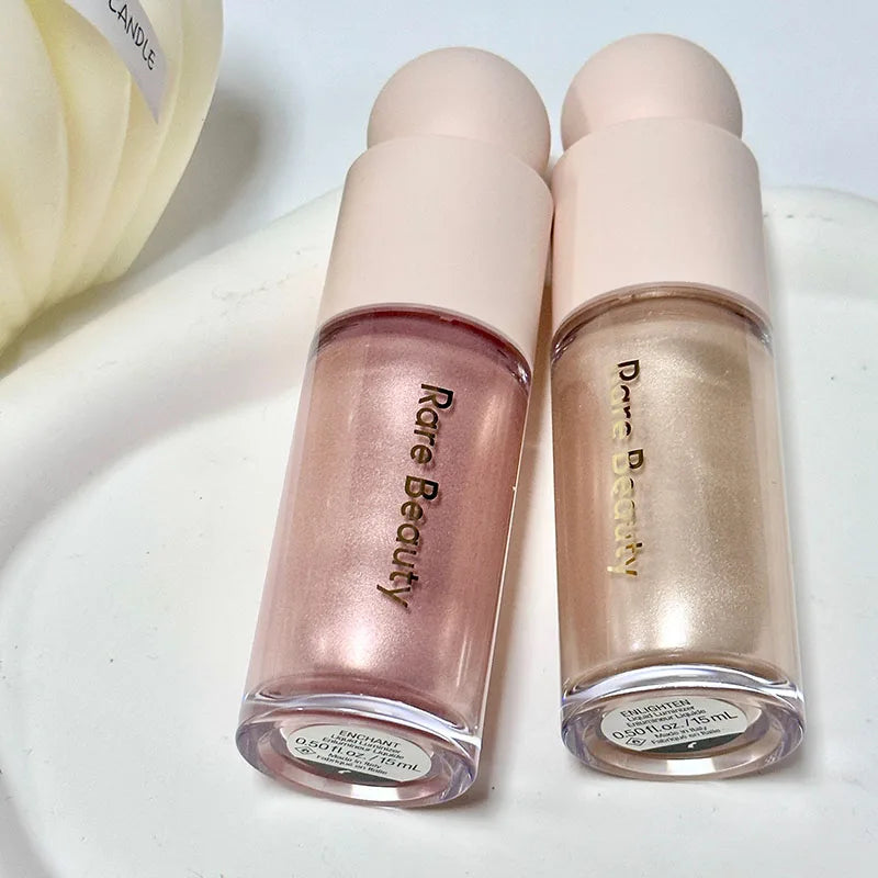 Rare Beauty Positive Light Liquid Luminizer in pink and gold shimmer shades with a silky, glowing finish.